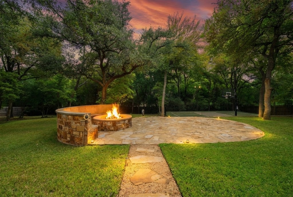 Luxury outdoor living with fire pit and sport court
