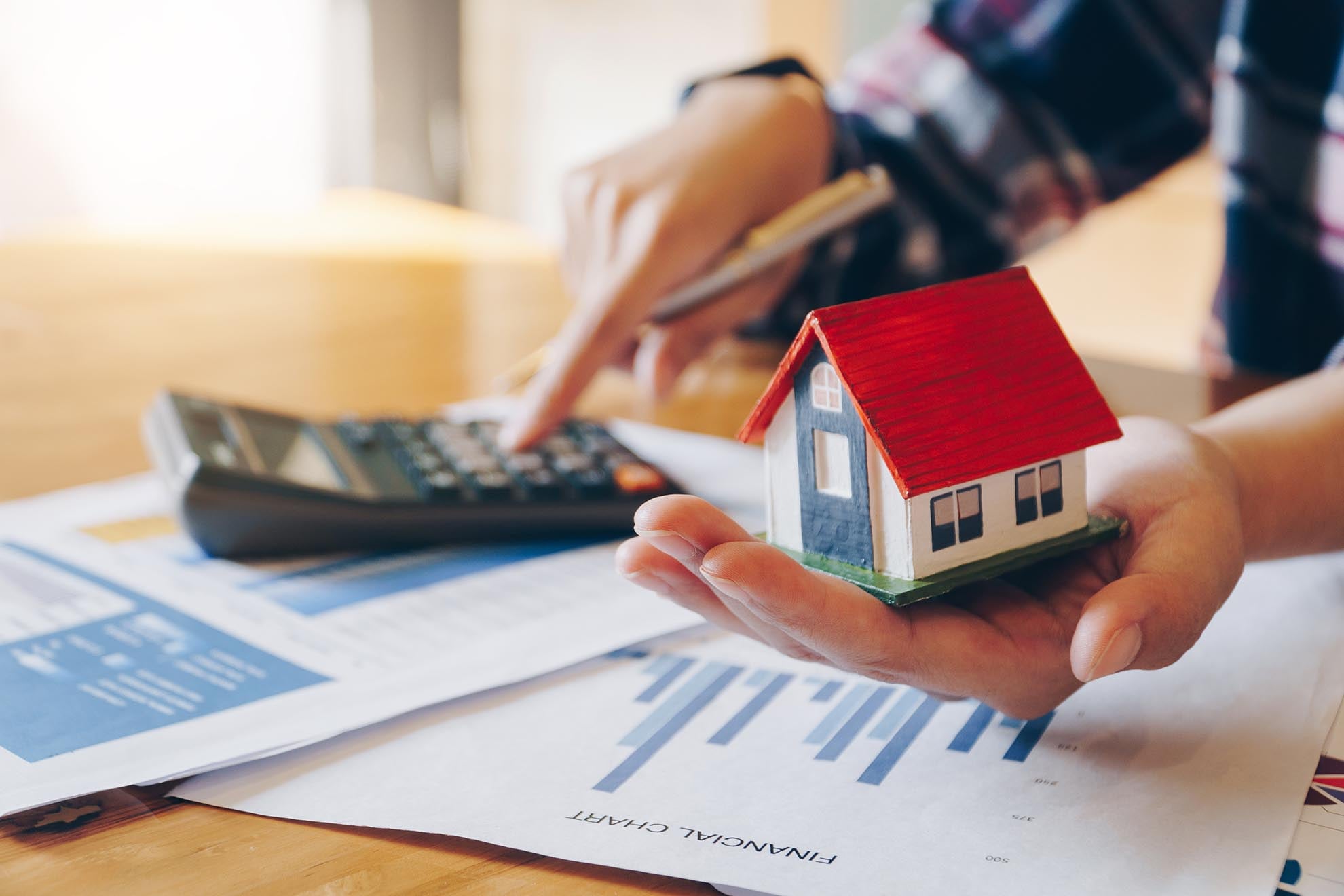 Woman calculating mortgage and tax figures for Texas real estate investment