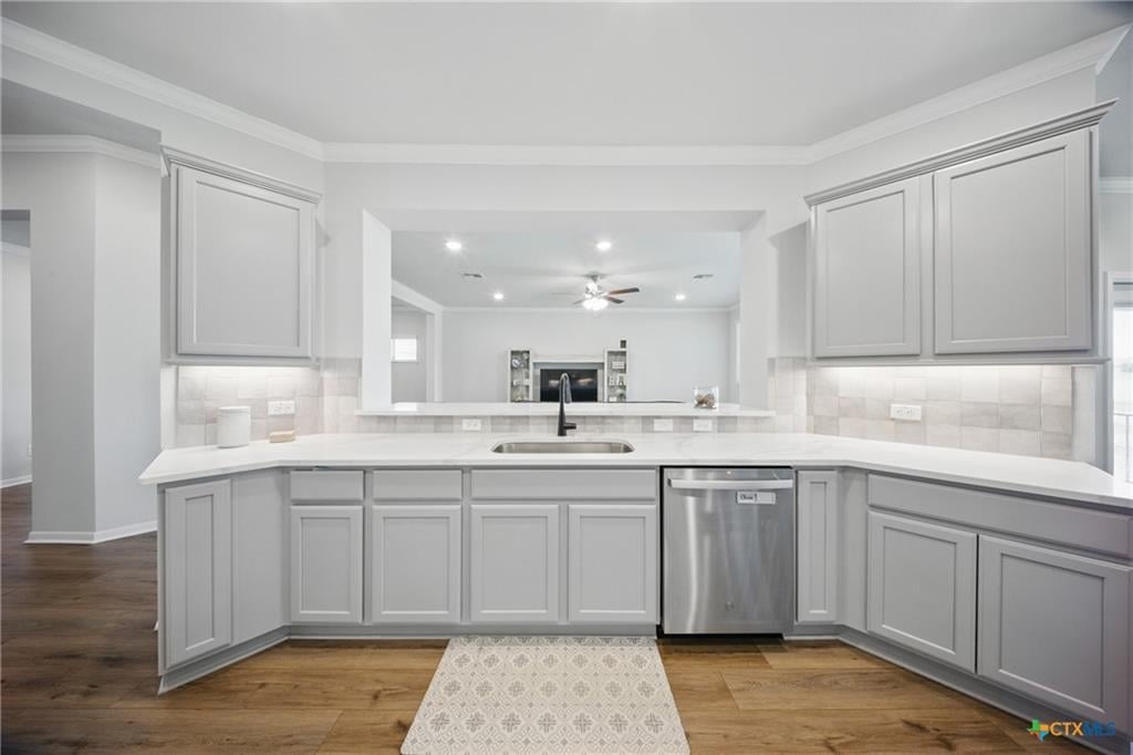 Standard Omega Builders kitchen in a Temple TX home — granite counters, stained birch cabinets, GE stainless appliances