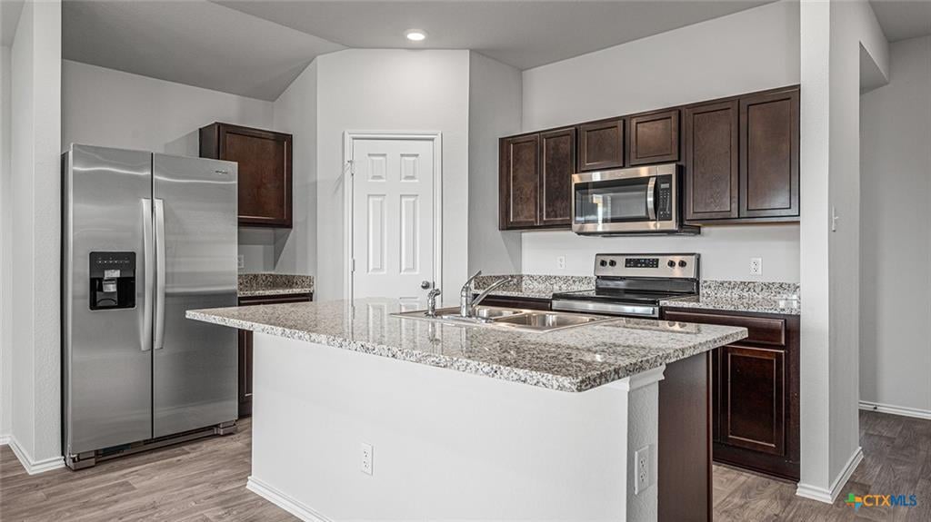 Example Pecan Creek kitchen with island, granite counters and open living connection