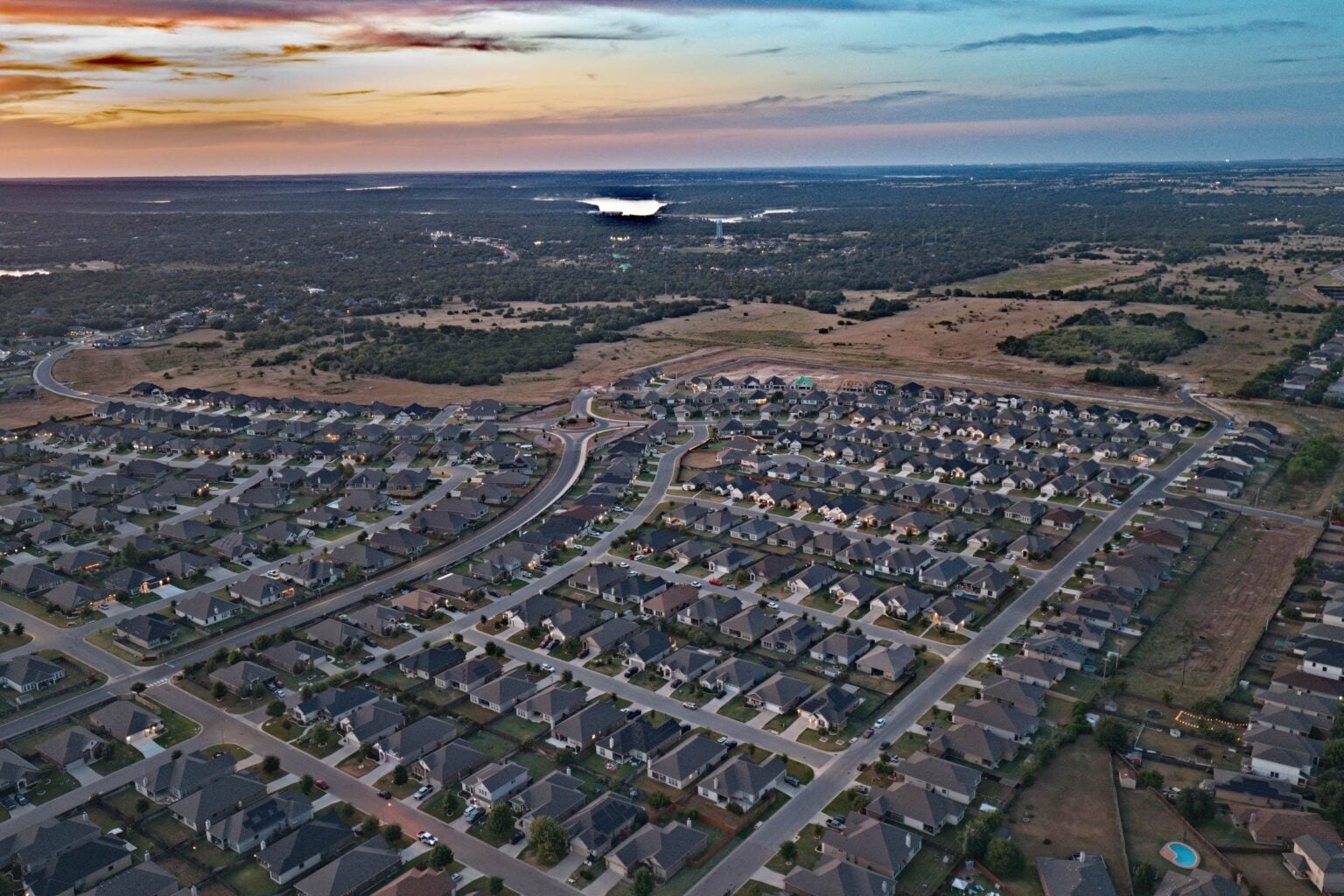 Homes in The Groves at Lakewood Ranch with Belton Lake on the horizon at dusk, photographed by Taylor Dasch