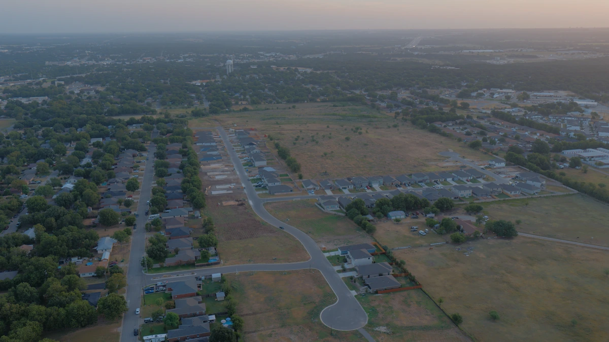 Aerial overview of Hidden Trails neighborhood streets and homes in Belton, Texas