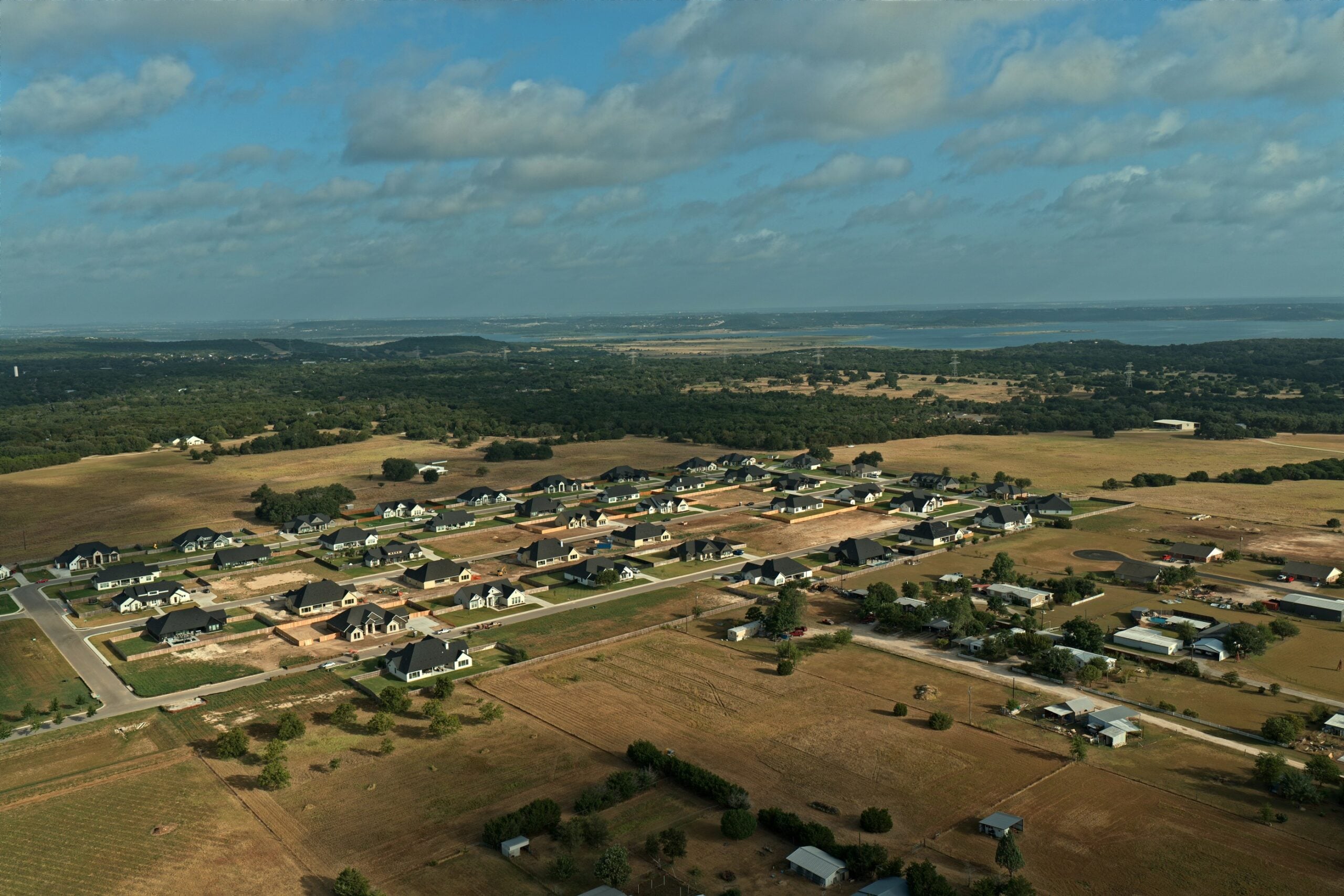 Aerial view of the King Oaks subdivision in Salado TX with Stillhouse Hollow Lake on the horizon