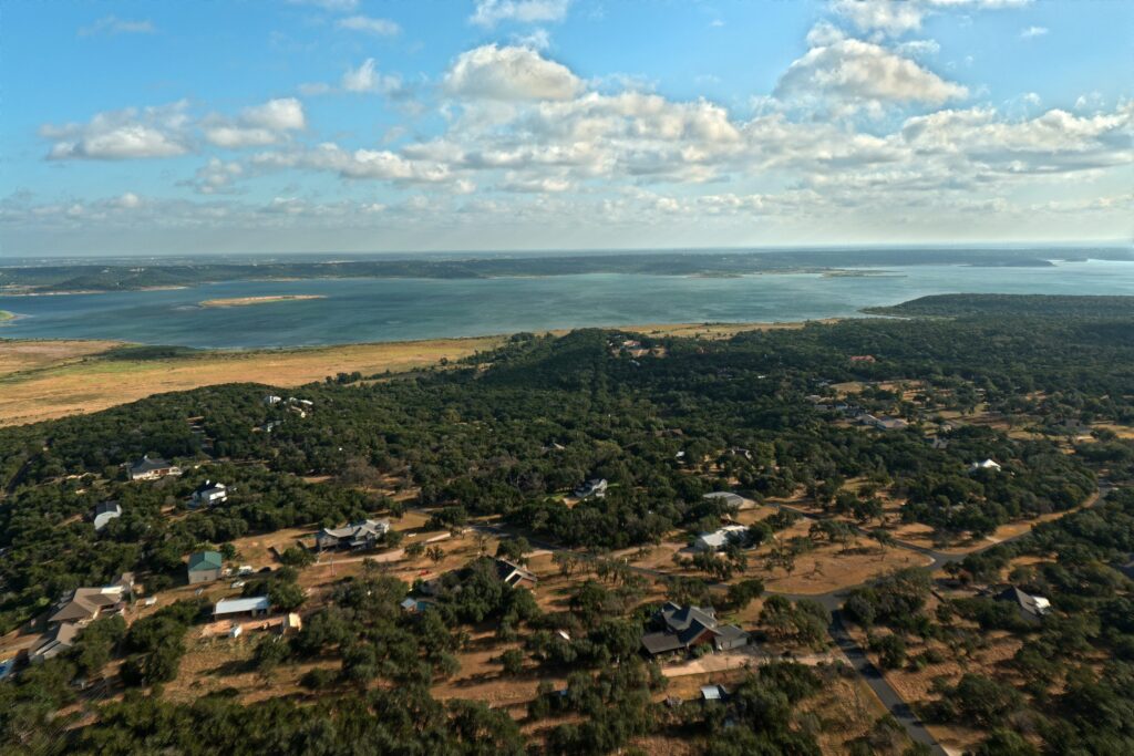 Stillhouse Hollow Lake aerial view near Harker Heights, Texas, with wooded ridgeline neighborhoods in the foreground