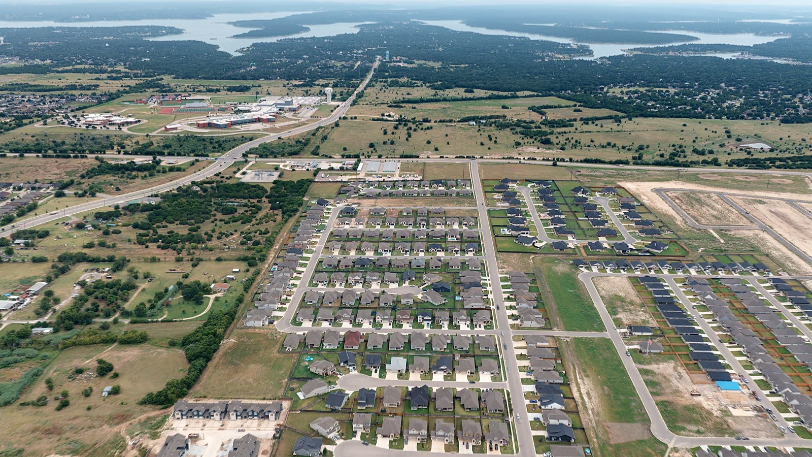 Aerial overview of Mesa Ridge in Temple TX showing the Belton ISD school campus, the highway corridor and active build-out sections