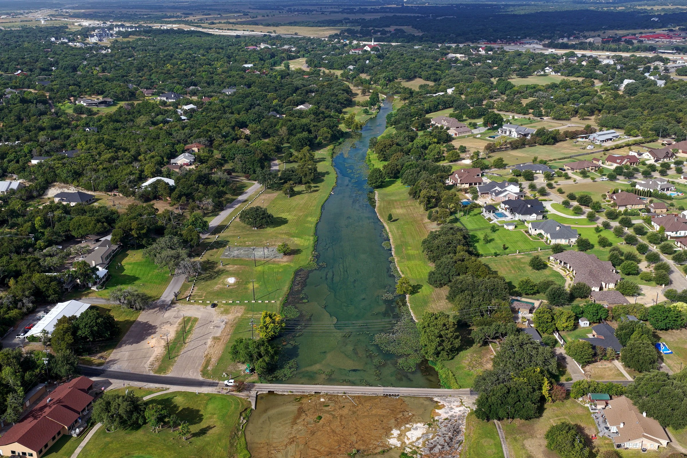 Aerial of Salado Creek through the Mill Creek golf course with creekside homes