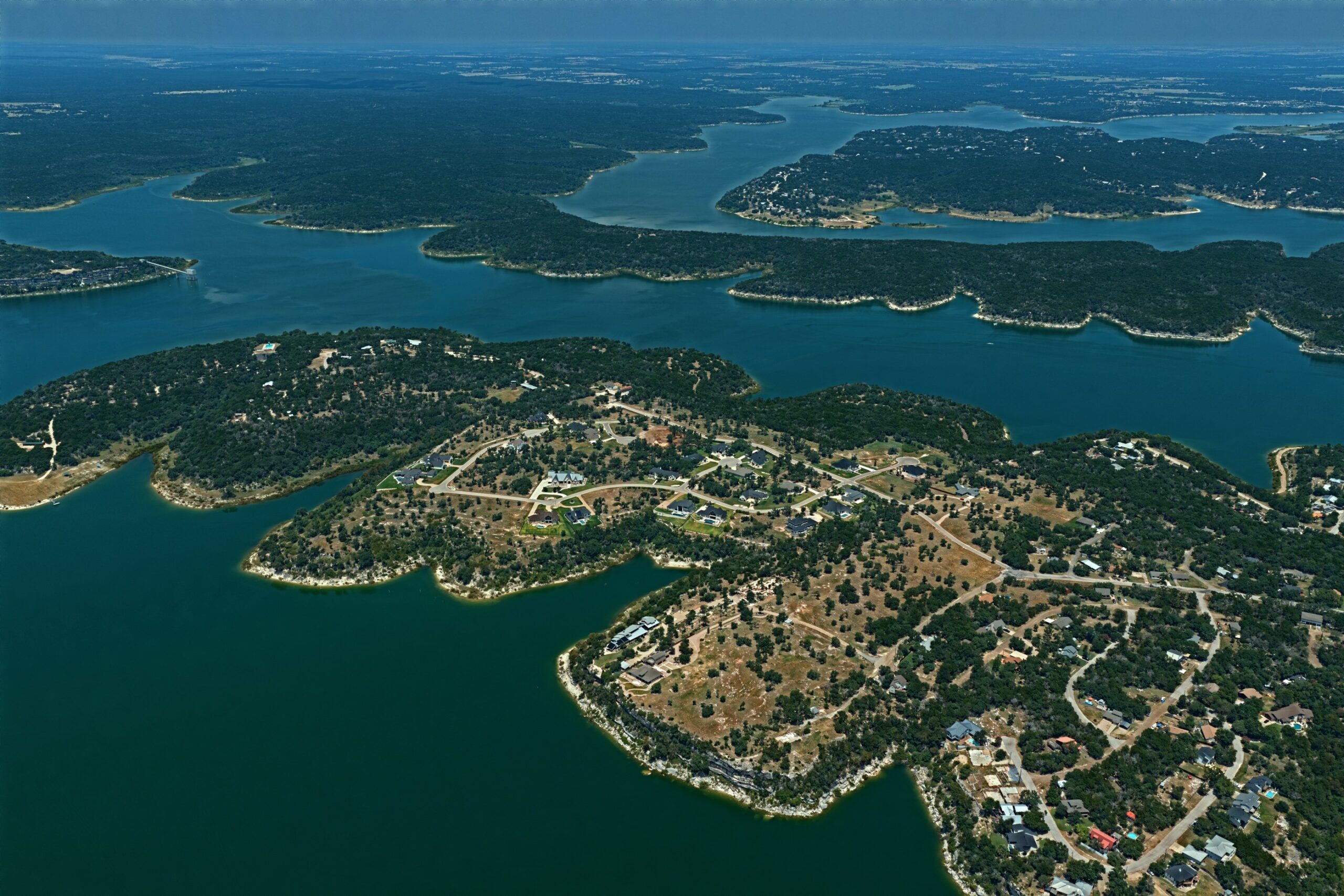 Aerial of Morgan’s Point Resort on Belton Lake showing the undeveloped Corps-managed shoreline belt between homes and the water