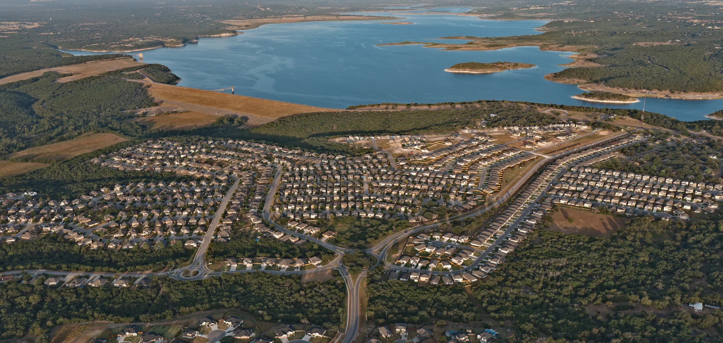 Aerial overview of Three Creeks neighborhood streets and homes in Belton, Texas