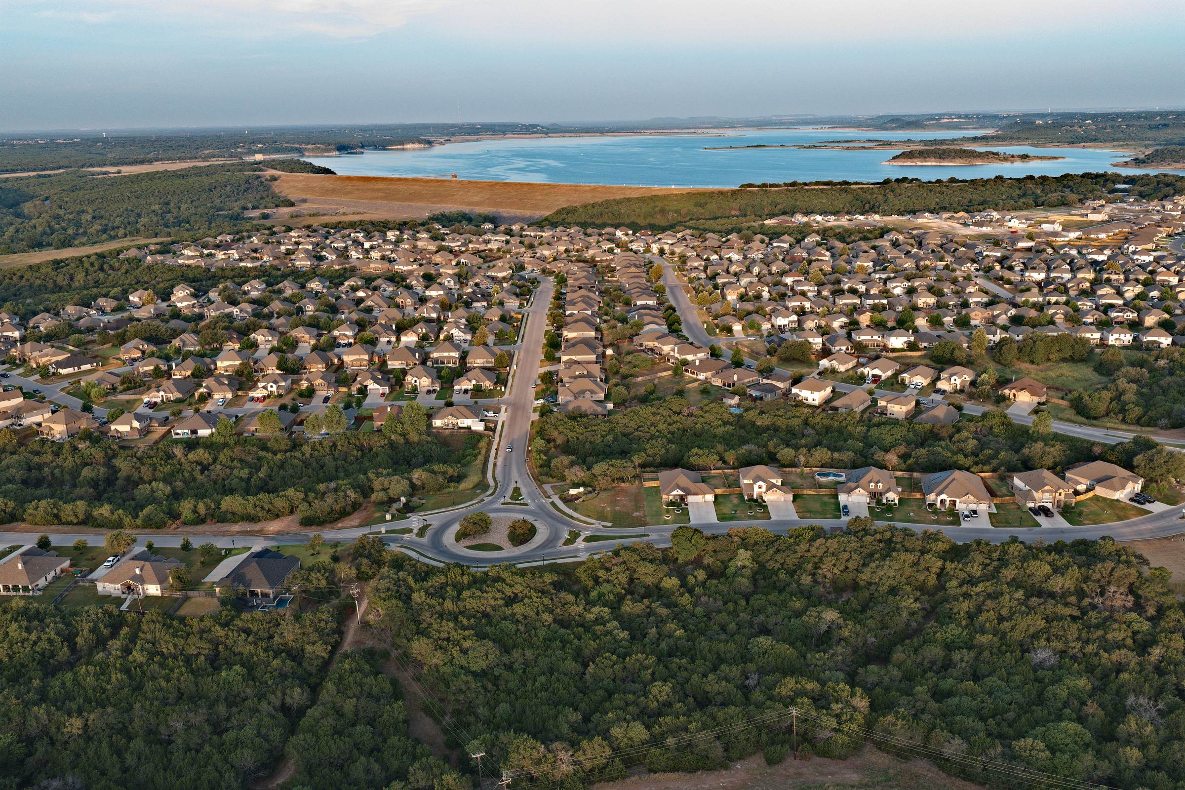 Three Creeks roundabout and community streets aerial with Belton Lake beyond, Belton TX