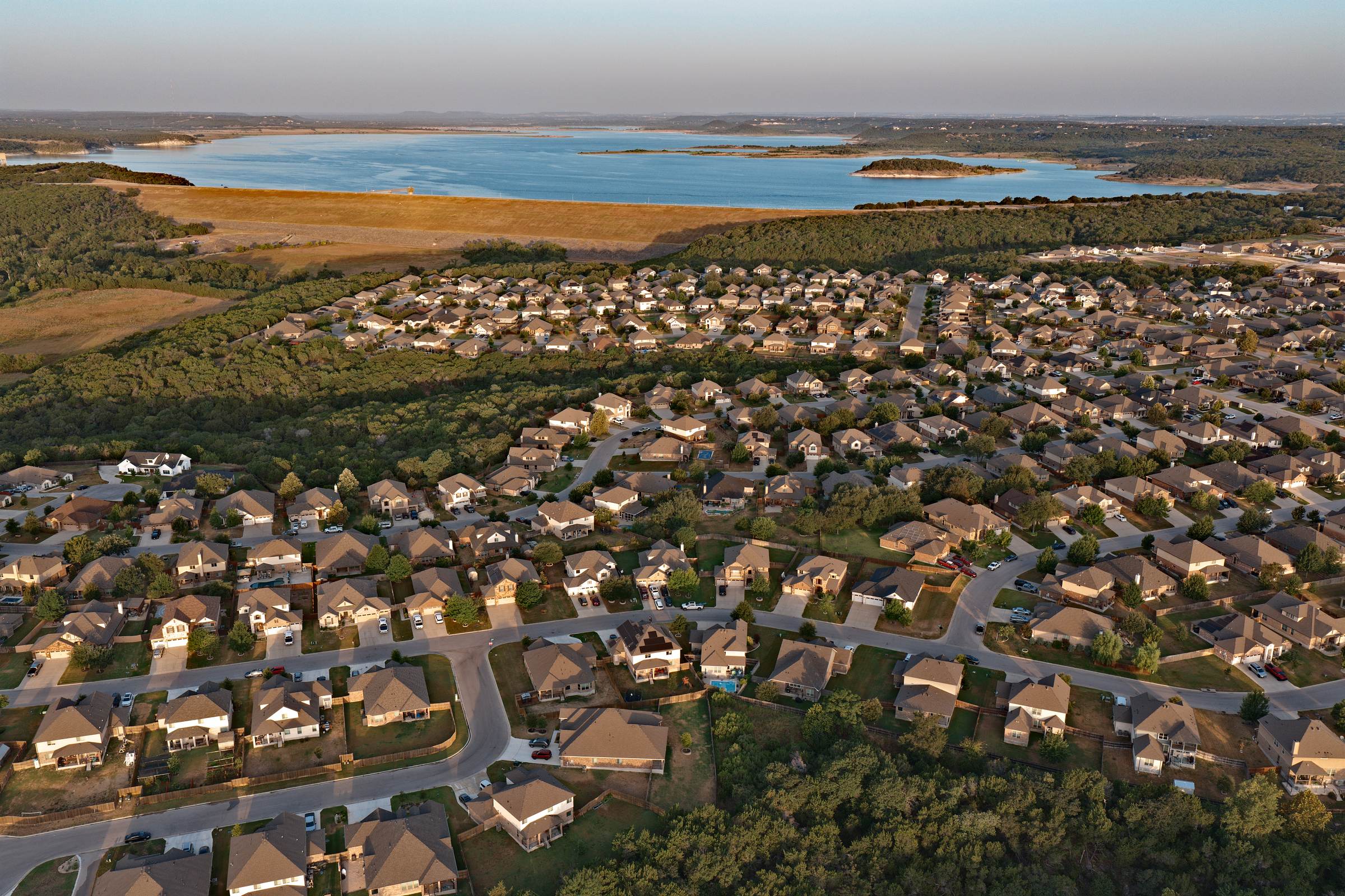 Three Creeks homes and streets aerial with Belton Lake behind, Belton TX