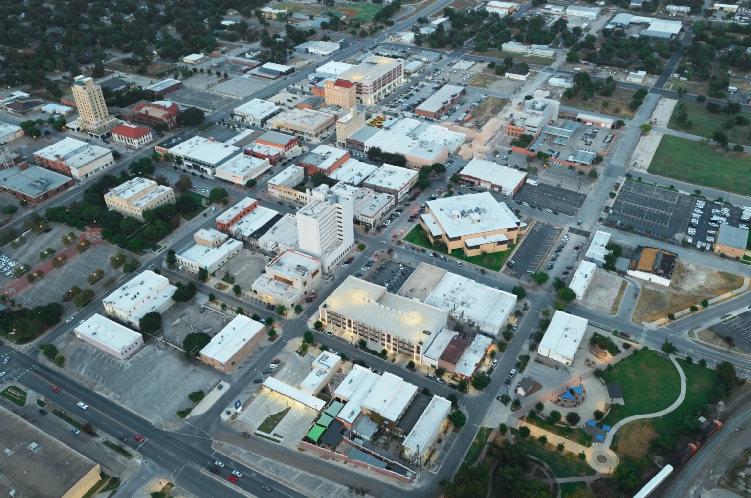 Aerial view of downtown Temple, Texas, at dusk, showing the city center and surrounding streets.