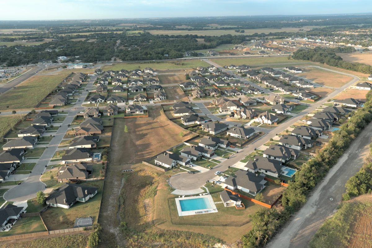 Aerial view of homes, streets, and a backyard pool in Legacy Ranch, west Temple, Texas