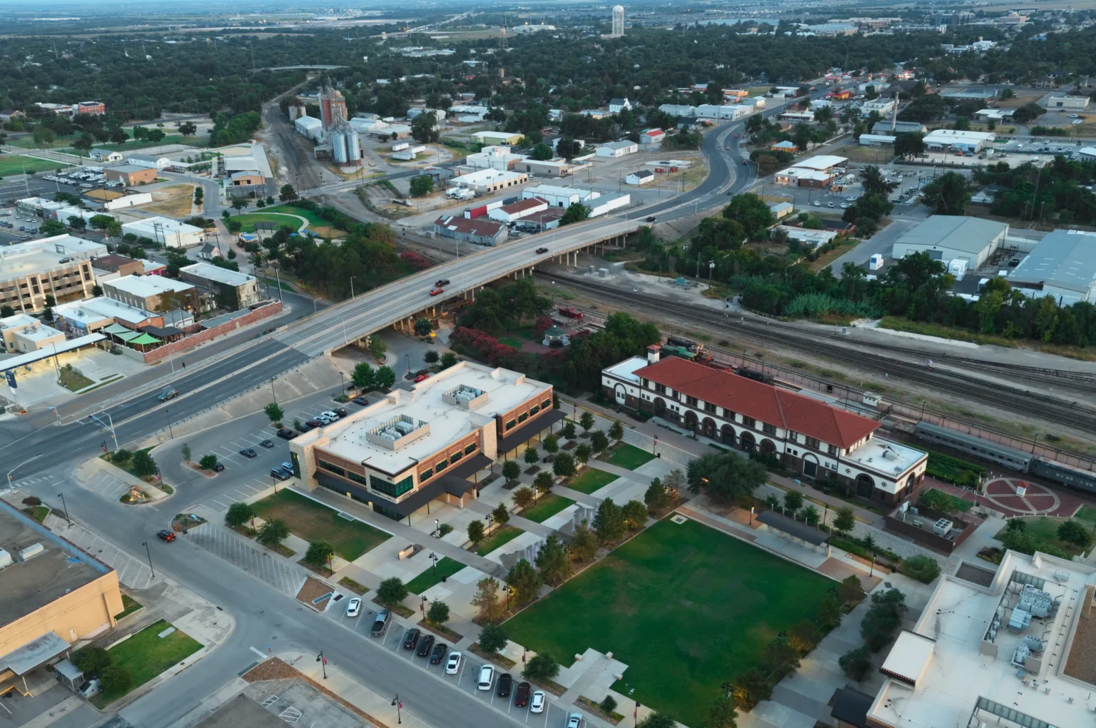 Santa Fe Plaza and the historic Santa Fe Depot in downtown Temple, Texas, seen from above at dusk