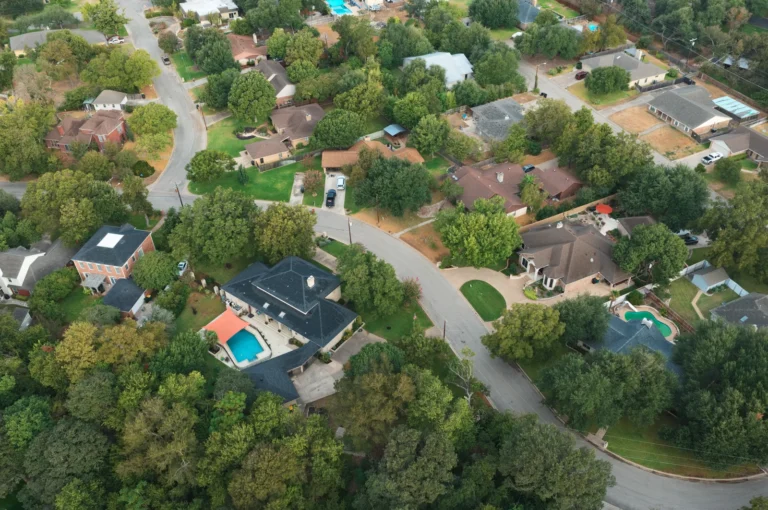 Aerial view of curving residential streets, homes and mature trees in the Canyon Creek area of Temple, Texas.