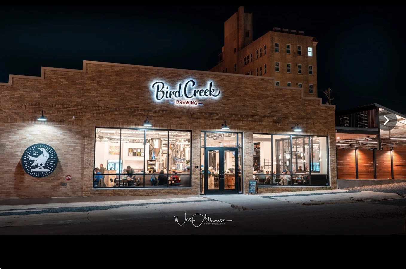 Bird Creek storefront at twilight in downtown Temple, Texas