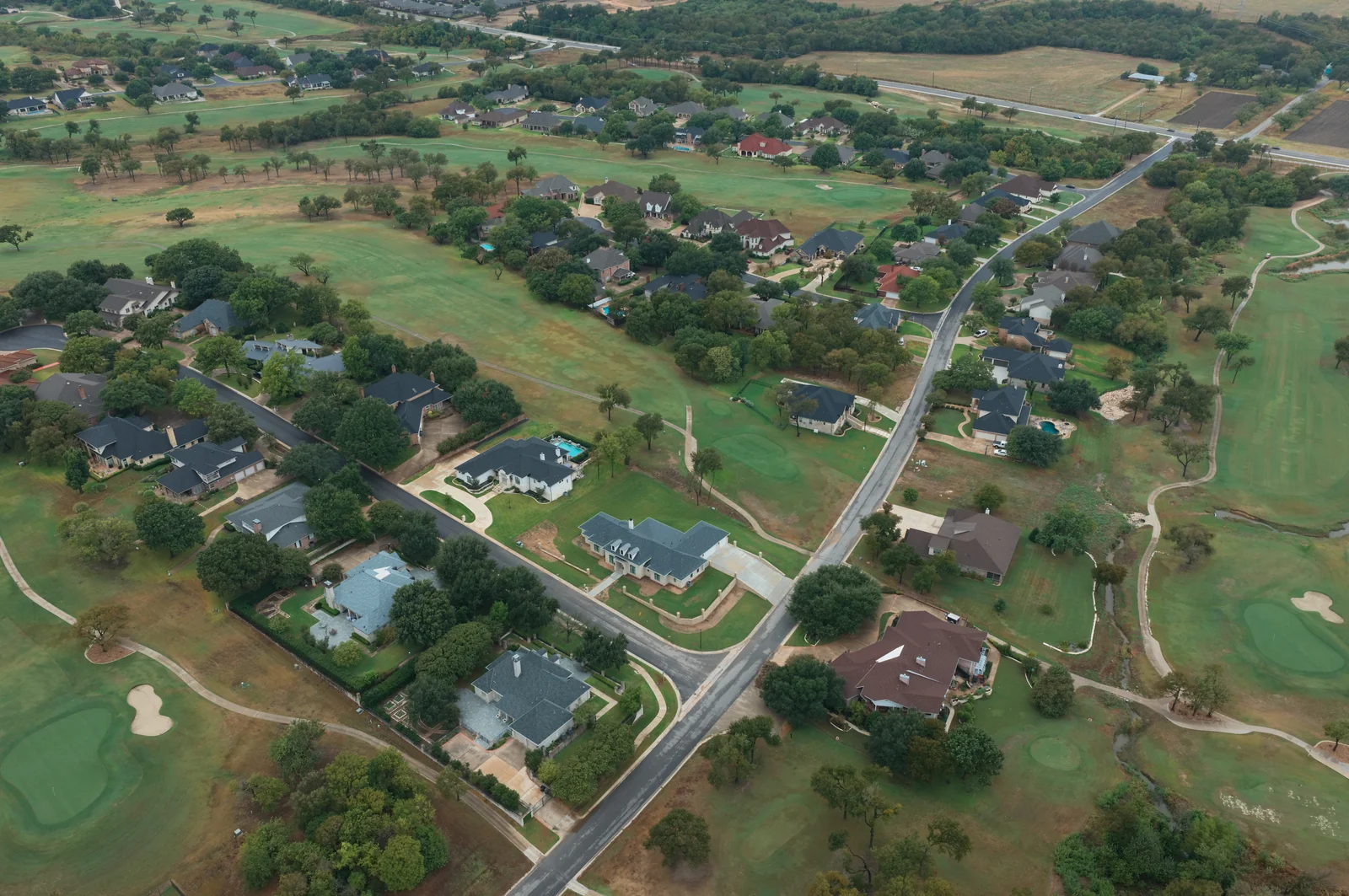 Residential streets weaving between homes and fairways in the Wildflower area.