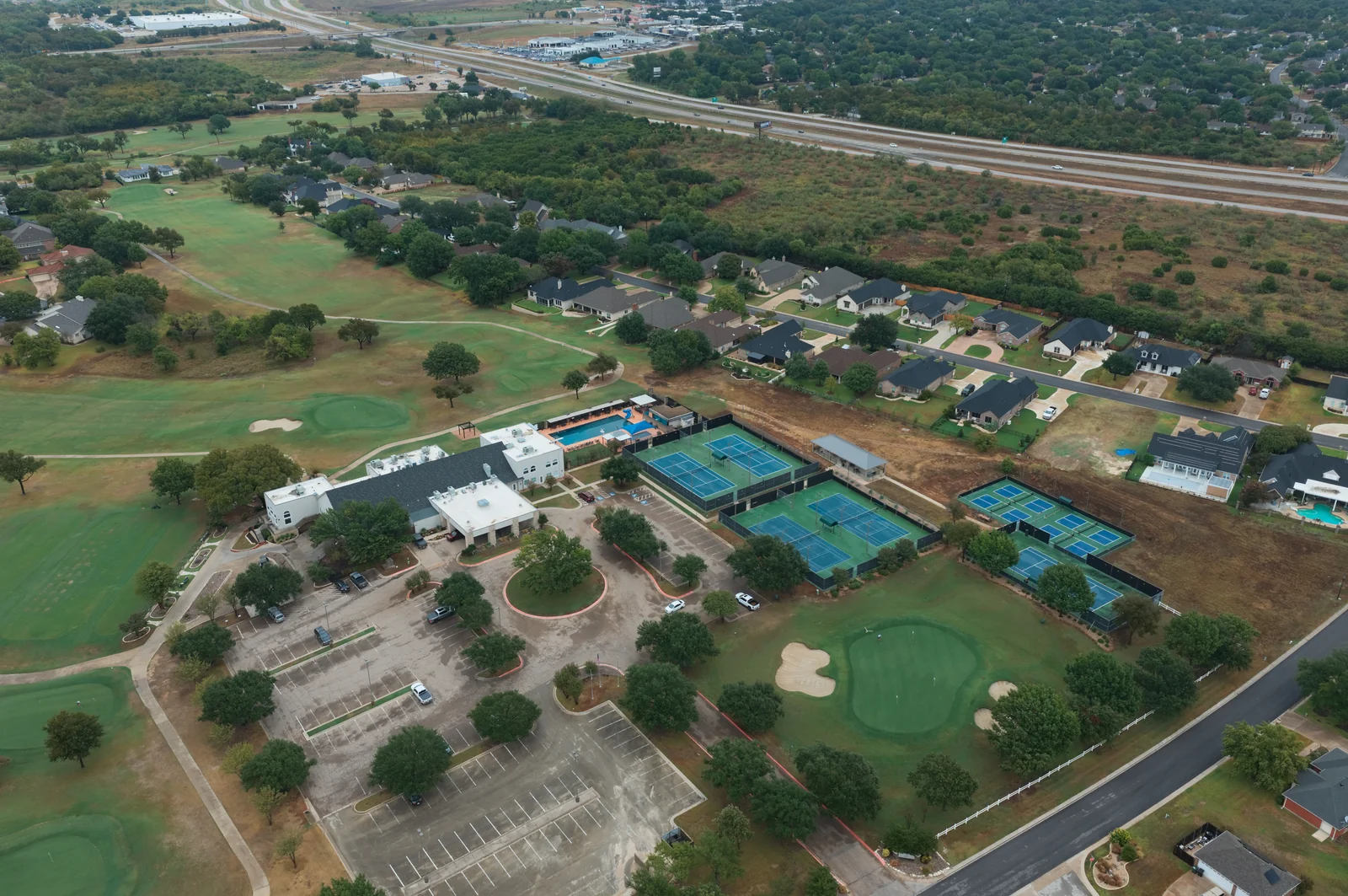 Aerial view of the clubhouse area, courts and swimming pool at Wildflower.